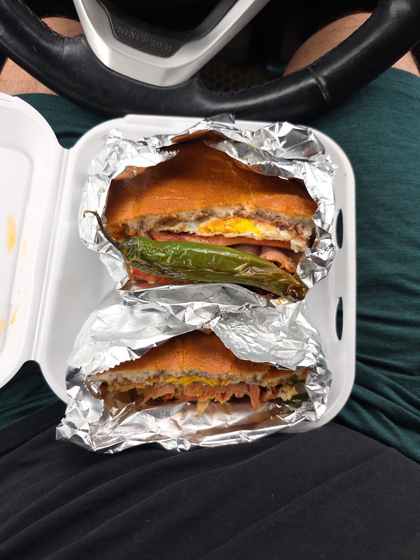 A loaded torta wrapped in foil with a roasted pepper