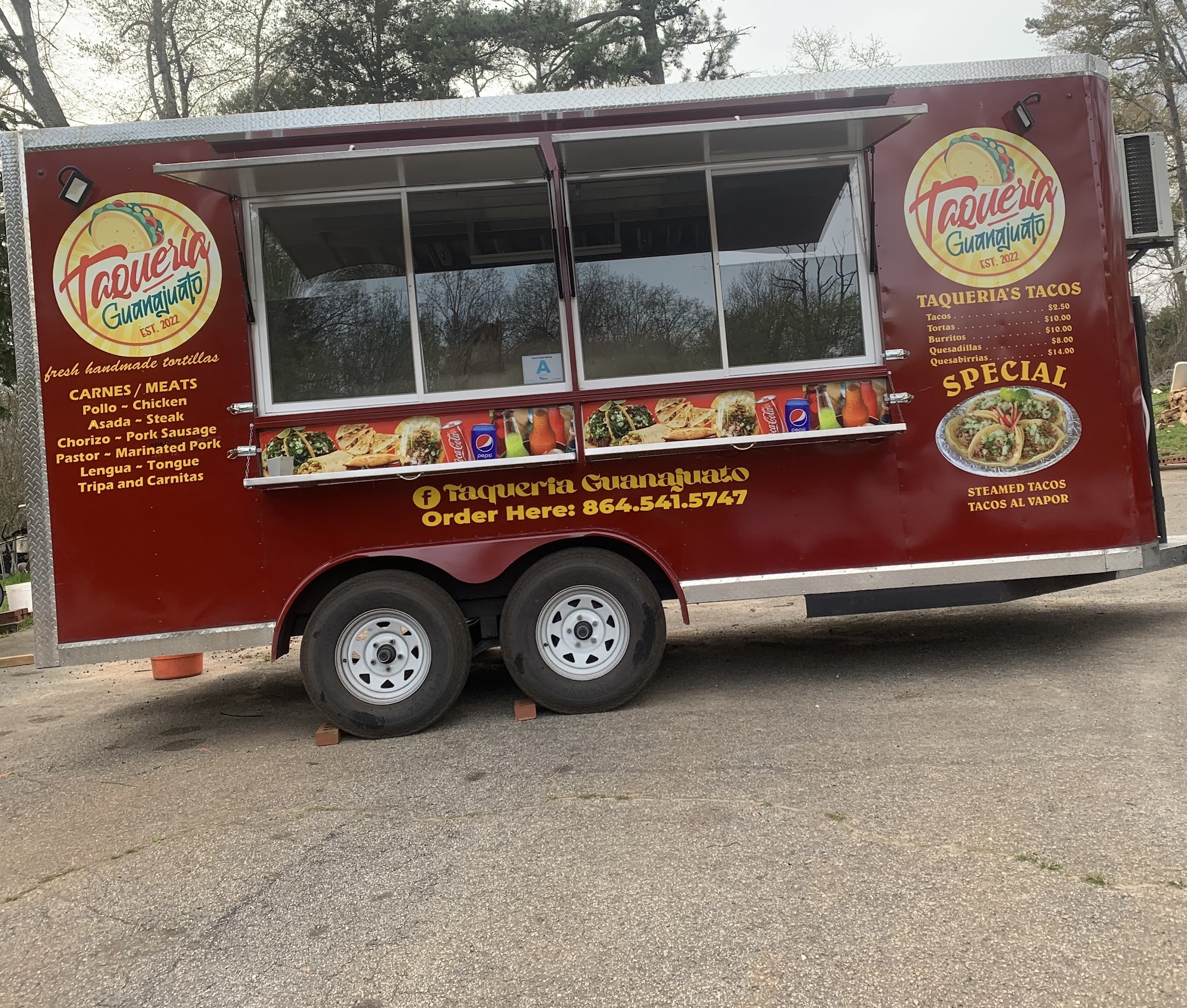 Our red truck with the Taqueria Guanajuato badge, printed menu and phone number