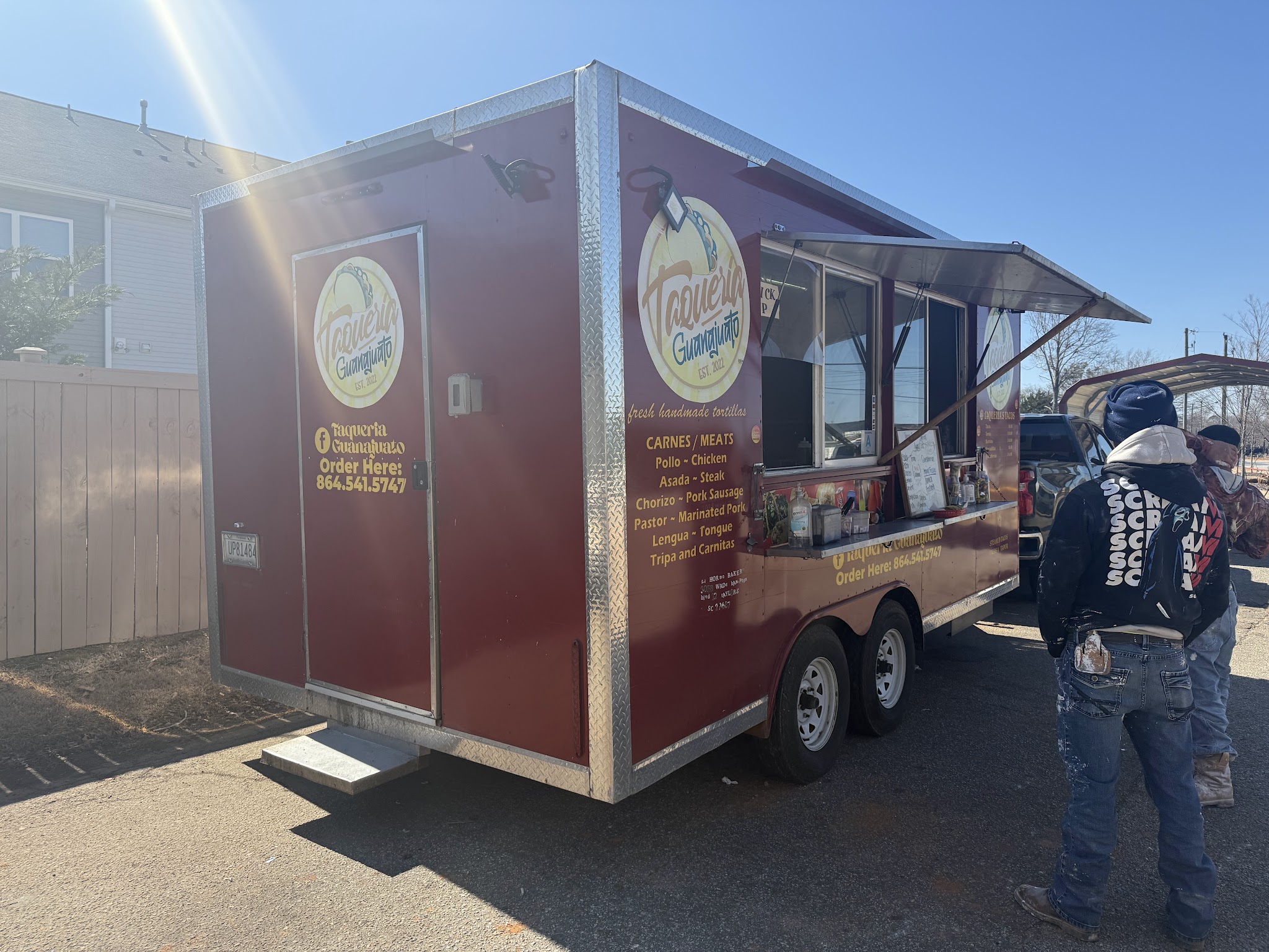 The red Taqueria Guanajuato food truck parked in the sun